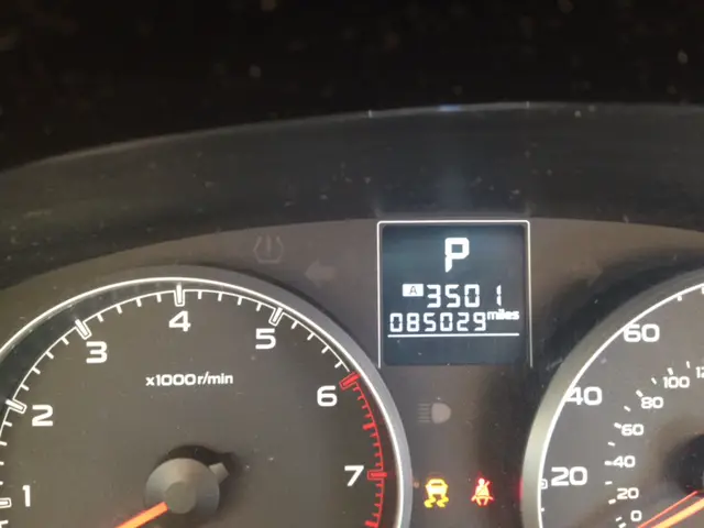 Dash of a car shows a mileage reading of 3501 miles