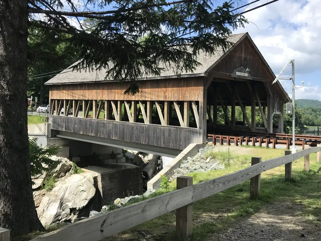 Large, covered bridge spans a river