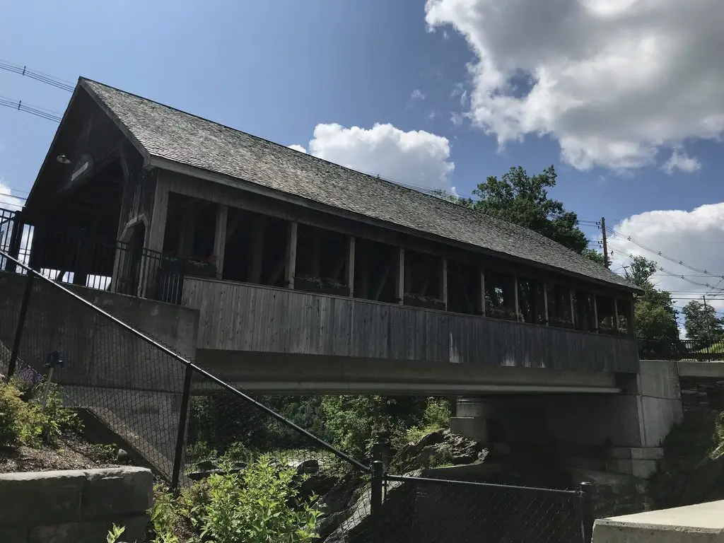 Large, covered bridge spans a river