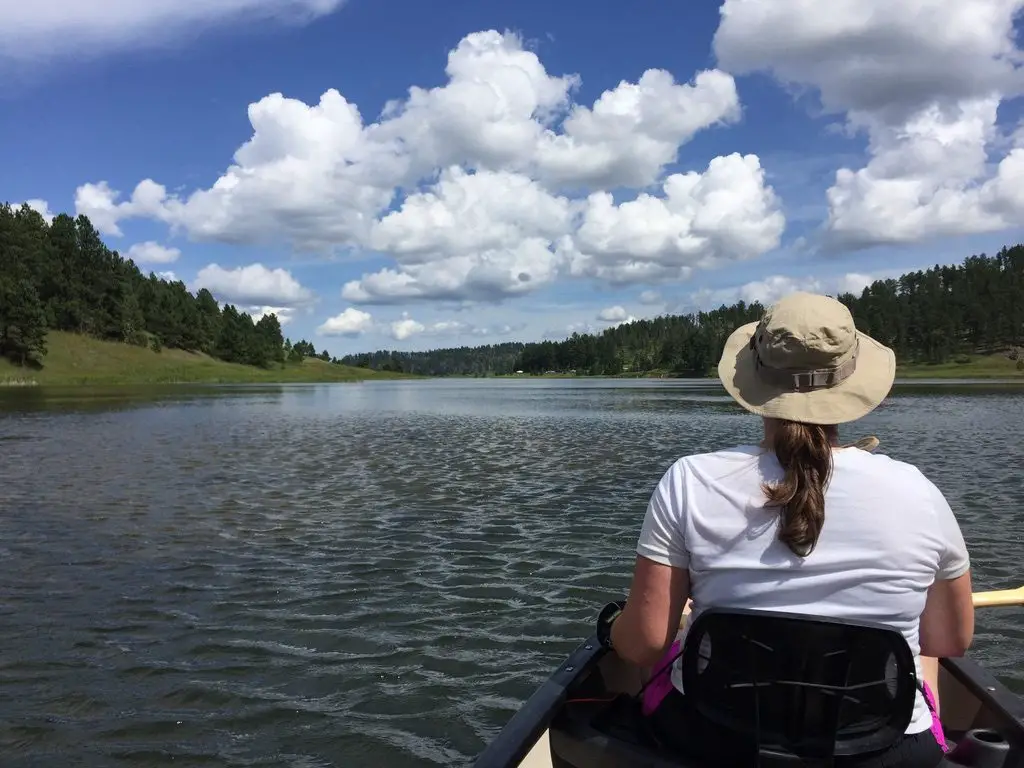 a woman canoeing on a lake