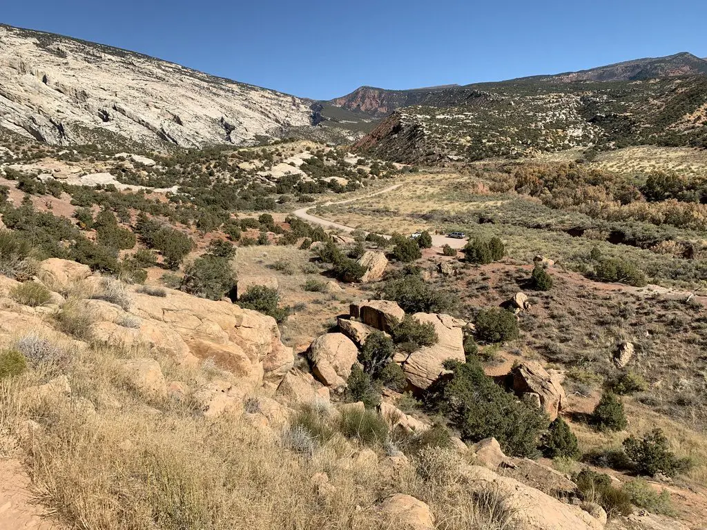 View over a desert landscape. Scrubbrush flatland leads to dry mountains in the background