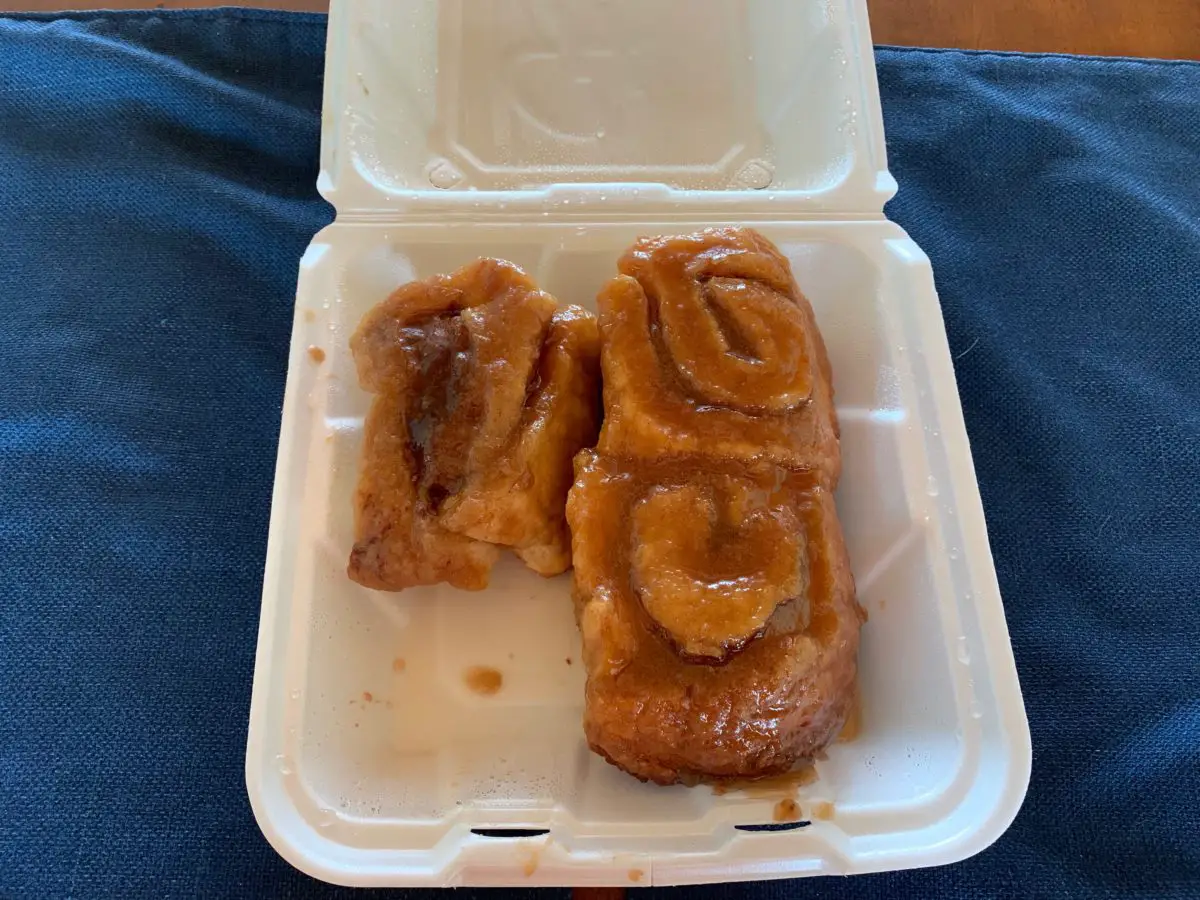3 gooey, carmel rolls in a takeout container