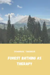 Green trees in the foreground with rocky and tree-covered mountains in the background. Pin reads, "Forest Bathing as Therapy"