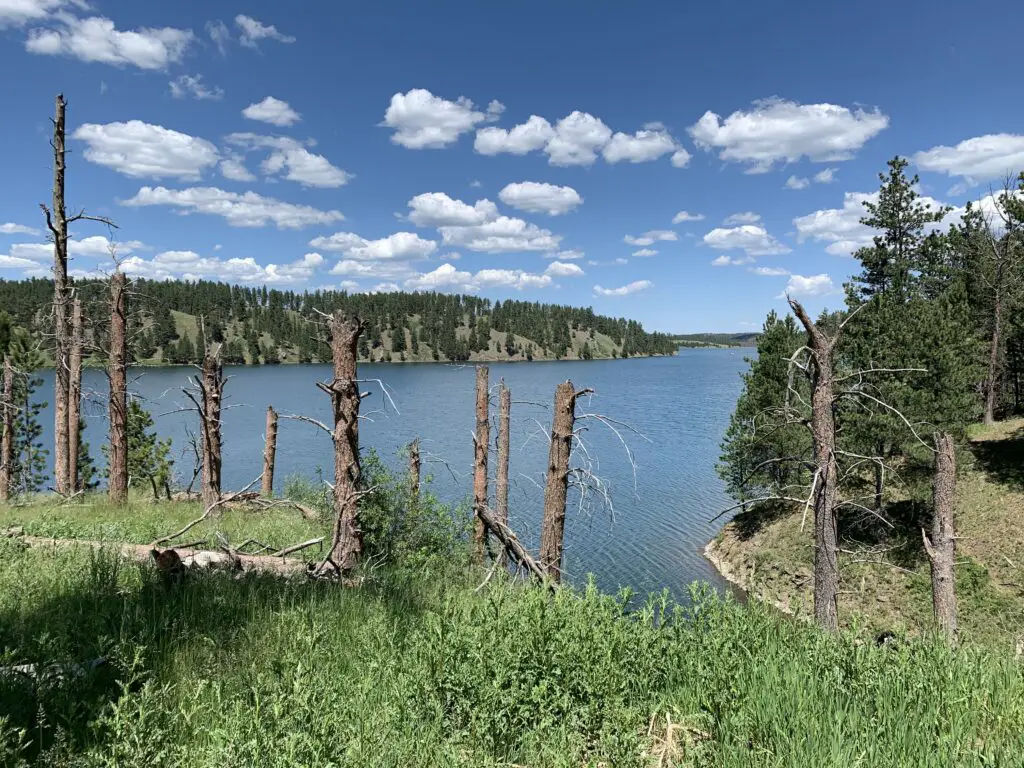 A large lake ringed by tree-covered mountains