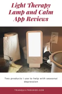 A sunlamp sits on a kitchen counter near other kitchen equipment. Pin reads, "Light Therapy Lamp and Calm App Reviews. Two products I use to help with Seasonal Depression." 