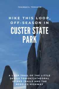 Two large, rock structures, one with a long, narrow hole, all under a blue sky. Pin reads, "Hike this loop, off-season in Custer State Park. A loop trail of the Little/Cathedral Spires Trails and the Needles Highway"