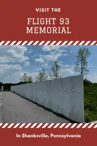 View down the length of a long, concrete wall with names written on it. Pin reads, "Visit the Flight 93 Memorial in Shanksville, Pennsylvania"