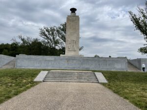 A large stone monument under a cloudy sky