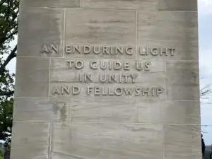A large stone monument that reads, "An enduring light to guide us in unity and fellowship".