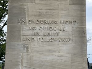 A large stone monument that reads, "An enduring light to guide us in unity and fellowship".