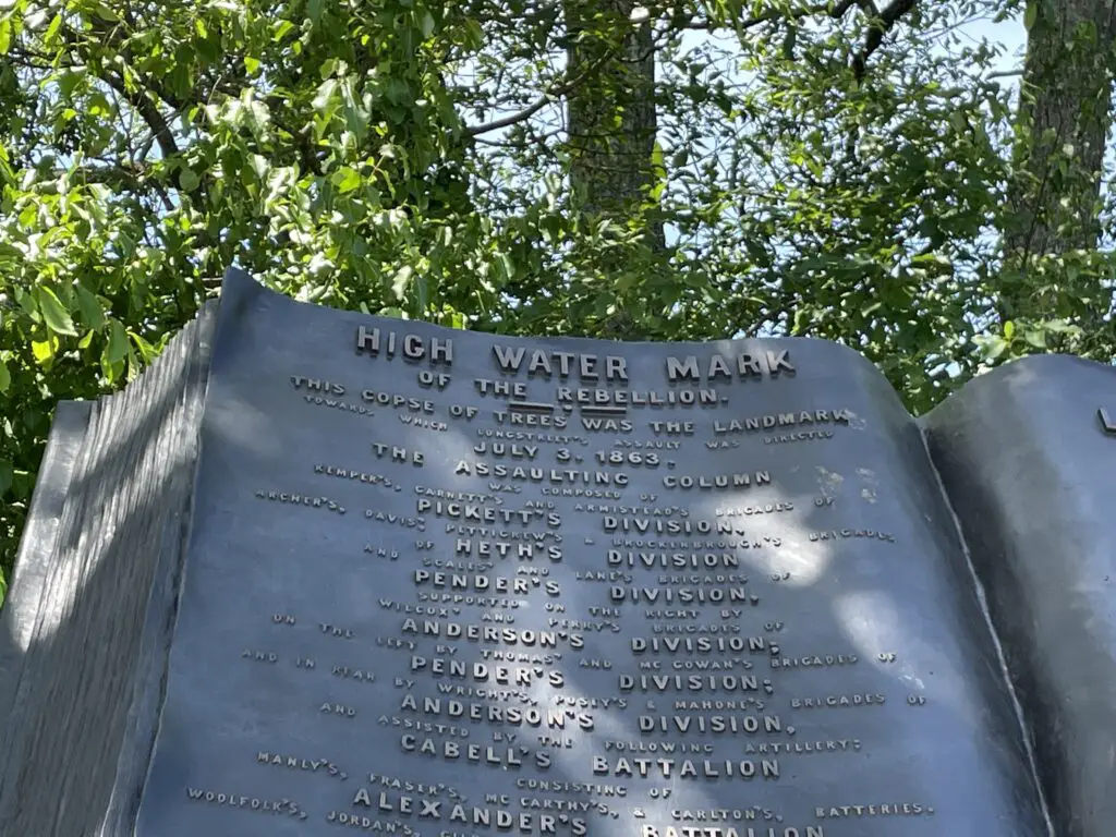 A large, bronze sculpture of a large book. It reads, "High Water Mark of the Rebellion" with numerous names, divisions and battalions listed below.