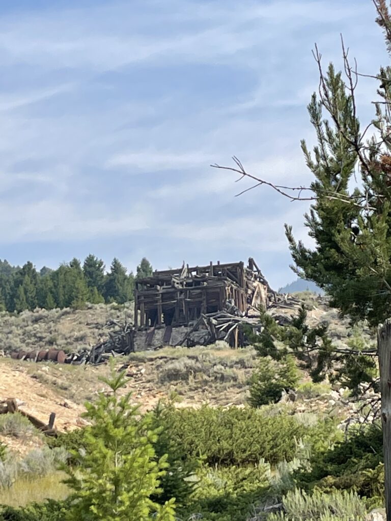 Old, decrepit, wooden mine stands on a mountainside