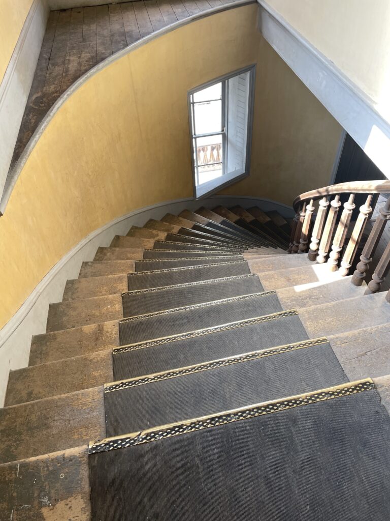 View down spiral, front staircase of old hotel.