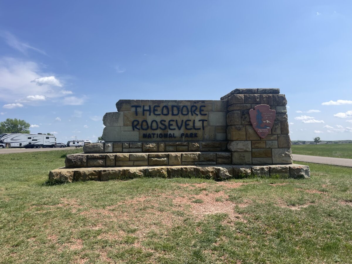 Large, stone sign that reads "Theodore Roosevelt National Park"